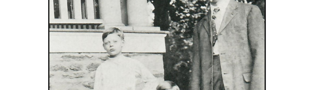 A man and two children standing in front of a house.